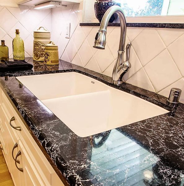 Cambria countertop in Sharpham and tile backsplash - black and white kitchen - Leslie Kate photo