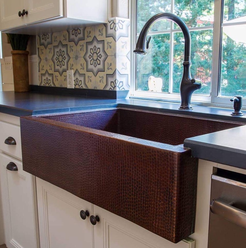 Black and white kitchen with copper farmhouse sink