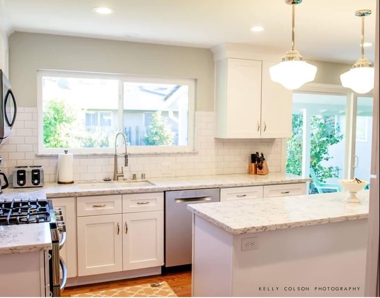 Full view white kitchen after remodel with quartz countertops - Kelly Colson photo